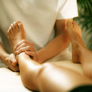 osteopath massaging leg for pain relief